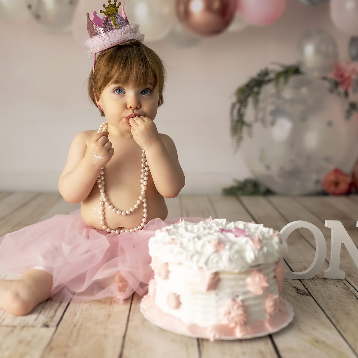 Niña con tutú y tarta de primer cumpleaños en una sesión infantil en Murcia